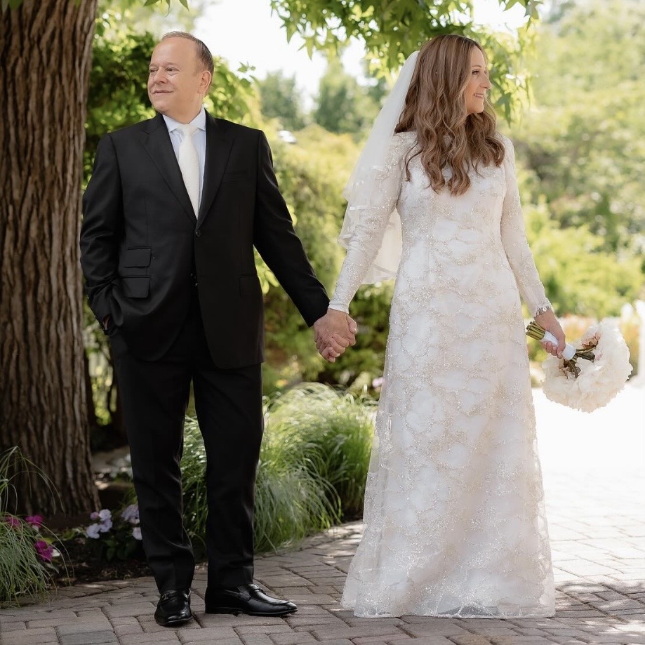 Client wearing a custom black suit at his wedding