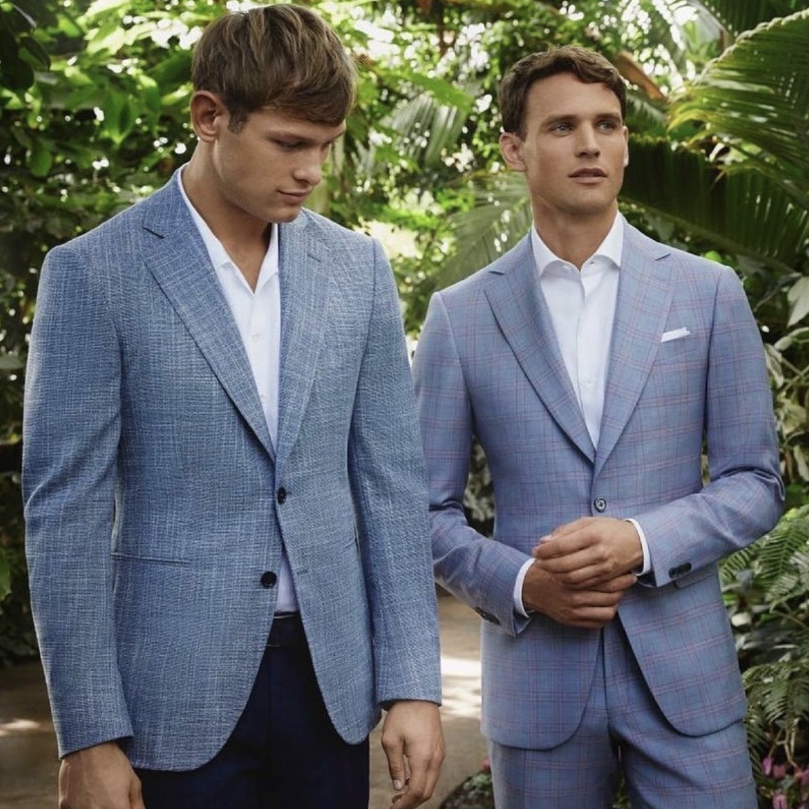Two men wearing tailored blue jackets